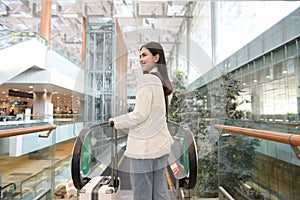 young beautiful woman walking with suitcase , check in at International airport , vacation travel and transportation concept