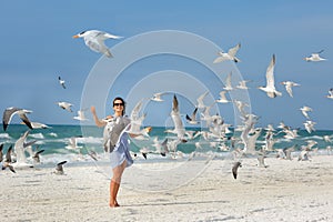 Young beautiful woman watching the seagulls flying