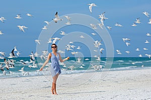 Young beautiful woman watching the seagulls flying