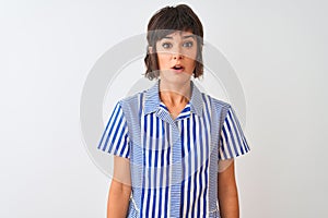 Young beautiful woman wearing blue striped shirt standing over isolated white background afraid and shocked with surprise