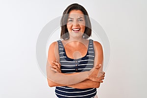 Young beautiful woman wearing blue striped t-shirt standing over isolated white background happy face smiling with crossed arms