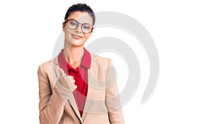 Young beautiful woman wearing business shirt and glasses doing happy thumbs up gesture with hand