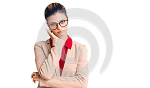 Young beautiful woman wearing business shirt and glasses thinking looking tired and bored with depression problems with crossed