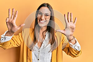 Young beautiful woman wearing business style and glasses showing and pointing up with fingers number nine while smiling confident