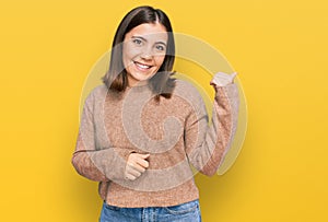 Young beautiful woman wearing casual clothes pointing to the back behind with hand and thumbs up, smiling confident