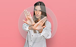 Young beautiful woman wearing casual clothes rejection expression crossing arms doing negative sign, angry face