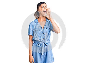 Young beautiful woman wearing casual clothes shouting and screaming loud to side with hand on mouth