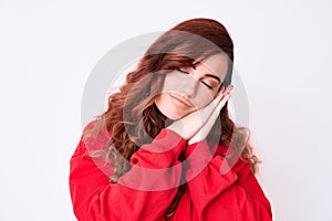 Young beautiful woman wearing casual clothes sleeping tired dreaming and posing with hands together while smiling with closed eyes