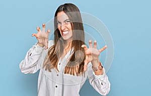 Young beautiful woman wearing casual clothes smiling funny doing claw gesture as cat, aggressive and sexy expression