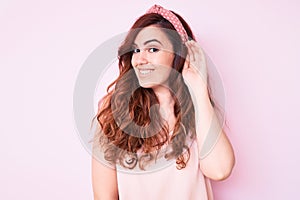 Young beautiful woman wearing casual clothes smiling with hand over ear listening an hearing to rumor or gossip