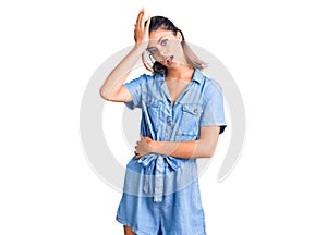 Young beautiful woman wearing casual clothes surprised with hand on head for mistake, remember error