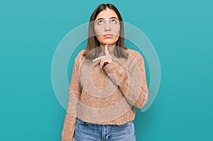 Young beautiful woman wearing casual clothes thinking concentrated about doubt with finger on chin and looking up wondering