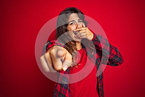 Young beautiful woman wearing casual jacket standing over red isolated background covering eyes with hand, looking serious and sad