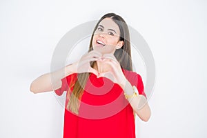 Young beautiful woman wearing casual red t-shirt over white isolated background smiling in love showing heart symbol and shape