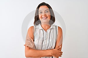 Young beautiful woman wearing casual striped shirt standing over isolated white background happy face smiling with crossed arms