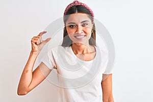 Young beautiful woman wearing casual t-shirt and diadem over isolated white background smiling and confident gesturing with hand