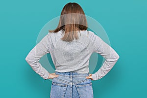 Young beautiful woman wearing casual turtleneck sweater standing backwards looking away with arms on body