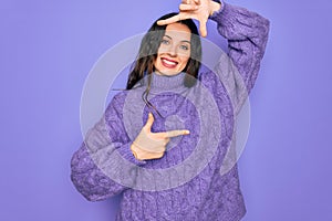 Young beautiful woman wearing casual turtleneck sweater standing over purple background smiling making frame with hands and