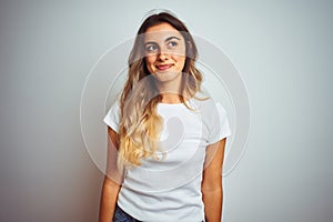 Young beautiful woman wearing casual white t-shirt over isolated background smiling looking to the side and staring away thinking