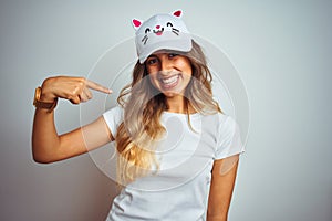 Young beautiful woman wearing cat cap over grey isolated background with surprise face pointing finger to himself