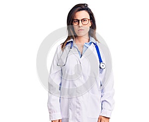 Young beautiful woman wearing doctor stethoscope and glasses skeptic and nervous, frowning upset because of problem