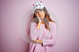 Young beautiful woman wearing funny cat cap standing over pink isolated background thinking looking tired and bored with