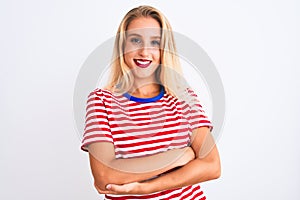 Young beautiful woman wearing red striped t-shirt standing over isolated white background happy face smiling with crossed arms