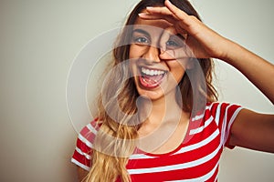 Young beautiful woman wearing red stripes t-shirt over white isolated background with happy face smiling doing ok sign with hand