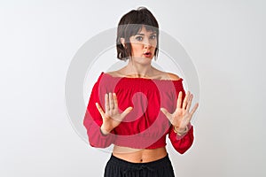 Young beautiful woman wearing red summer t-shirt standing over isolated white background Moving away hands palms showing refusal