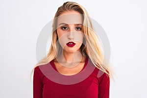 Young beautiful woman wearing red t-shirt standing over isolated white background with a confident expression on smart face