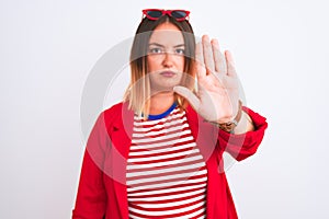 Young beautiful woman wearing striped t-shirt and jacket over isolated white background doing stop sing with palm of the hand