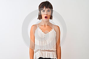 Young beautiful woman wearing summer casual t-shirt standing over isolated white background afraid and shocked with surprise