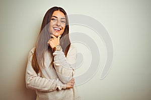 Young beautiful woman wearing winter turtleneck sweater over isolated white background looking confident at the camera smiling