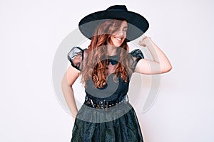 Young beautiful woman wearing witch halloween costume stretching back, tired and relaxed, sleepy and yawning for early morning