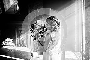 Young beautiful woman in wedding dress with bouquet of flowers. Wedding hairstyle, flowers in hair.