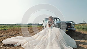 Young Beautiful Woman In Wedding Dress Posing Near Vintage Car.