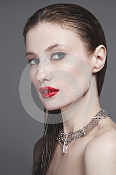 Young beautiful woman with wet hair and red lips