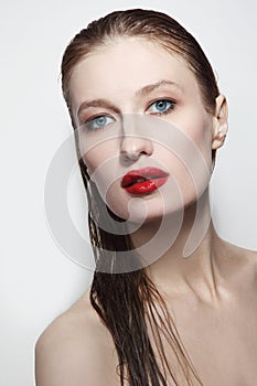 Young beautiful woman with wet hair and red lips