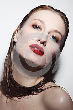 Young beautiful woman with wet hair and red lips