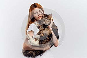 Young beautiful woman on white background holds a cat, pets, animals, girl