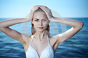 Young beautiful woman in a white bathing suit bathes in the sea, vacation, vacation, beach, water, summer