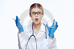 Young beautiful woman on white isolated background holds a syringe, doctor, medicine