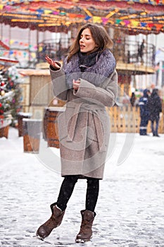 Young beautiful woman in white short mink coat