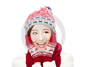 Young beautiful woman in winter clothes and touching face