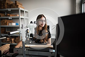 Young beautiful woman work in students laboratory. Student working in lab.