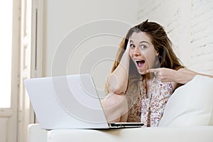 Young beautiful woman working with laptop computer smiling happy or doing online internet shopping