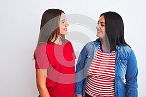 Young beautiful women wearing casual clothes standing over isolated white background with a happy and cool smile on face