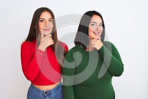 Young beautiful women wearing casual clothes standing over isolated white background looking confident at the camera with smile