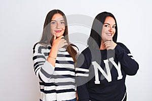 Young beautiful women wearing casual clothes standing over isolated white background looking confident at the camera with smile