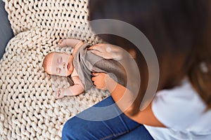 Young beautifull woman and her baby on the sofa over blanket at home